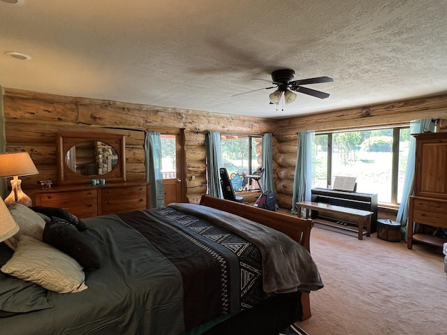 bedroom featuring a ceiling fan, a textured ceiling, and light colored carpet