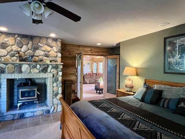 carpeted bedroom featuring rustic walls and ceiling fan