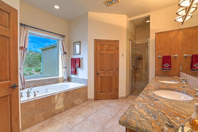 bathroom with tile patterned flooring, sink, and plus walk in shower