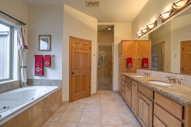 bathroom with vanity, tile patterned floors, and plus walk in shower