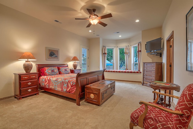 bedroom featuring light colored carpet and ceiling fan