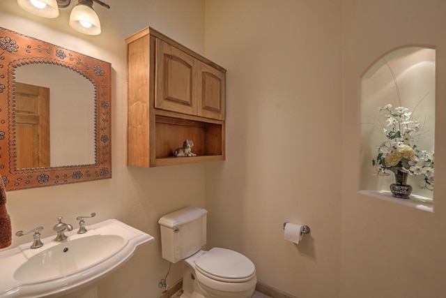 bathroom featuring toilet and sink