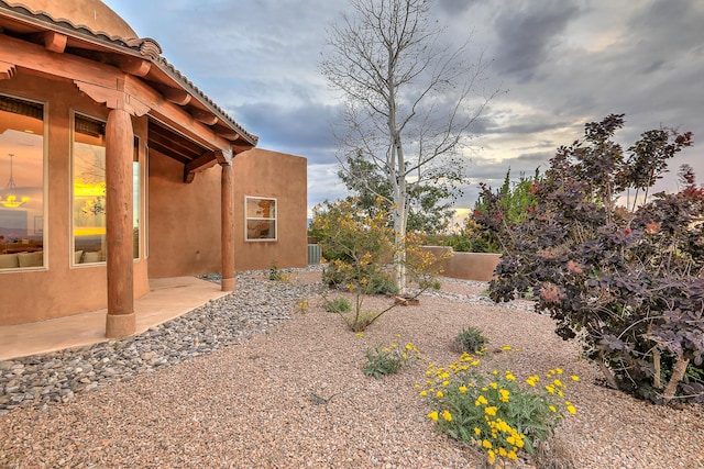 yard at dusk featuring a patio area