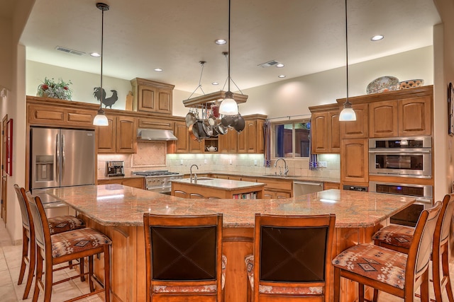 kitchen featuring a large island, sink, pendant lighting, and appliances with stainless steel finishes