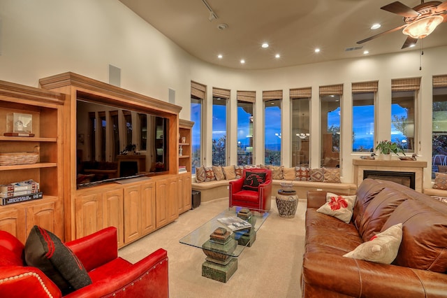 carpeted living room featuring ceiling fan