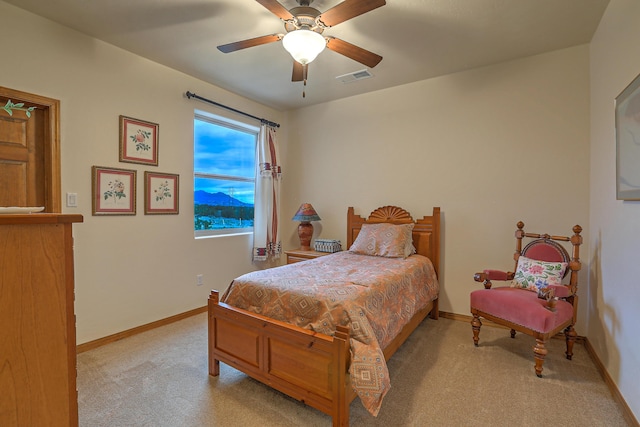 bedroom featuring light colored carpet and ceiling fan