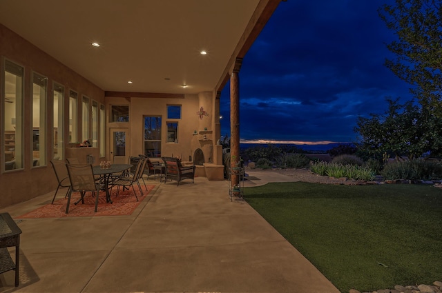 patio terrace at dusk with a lawn