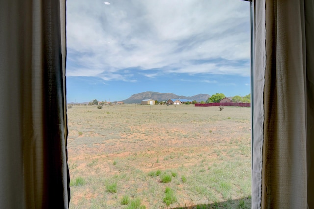 view of yard featuring a mountain view and a rural view