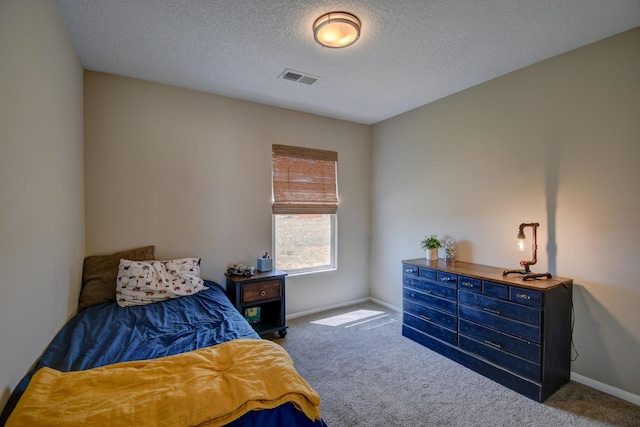 bedroom with carpet and a textured ceiling