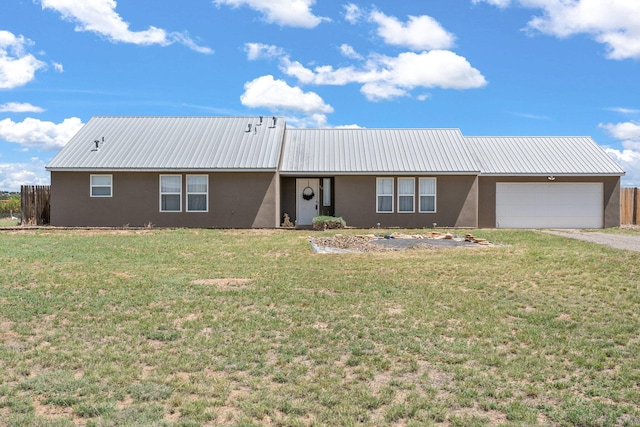 single story home featuring a front lawn and a garage