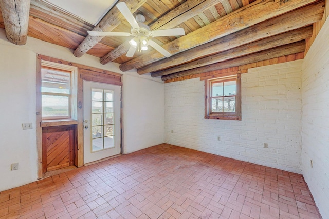 unfurnished room featuring brick wall, wooden ceiling, and ceiling fan