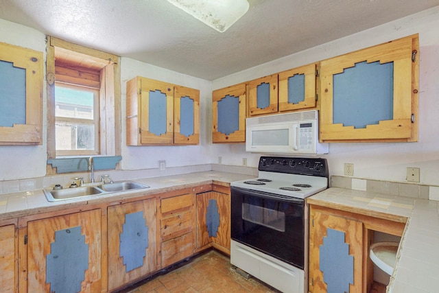 kitchen with white appliances, light tile patterned floors, a textured ceiling, tile countertops, and sink