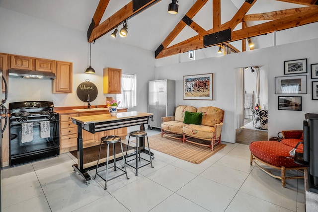 kitchen featuring gas stove, rail lighting, light tile patterned floors, beamed ceiling, and high vaulted ceiling