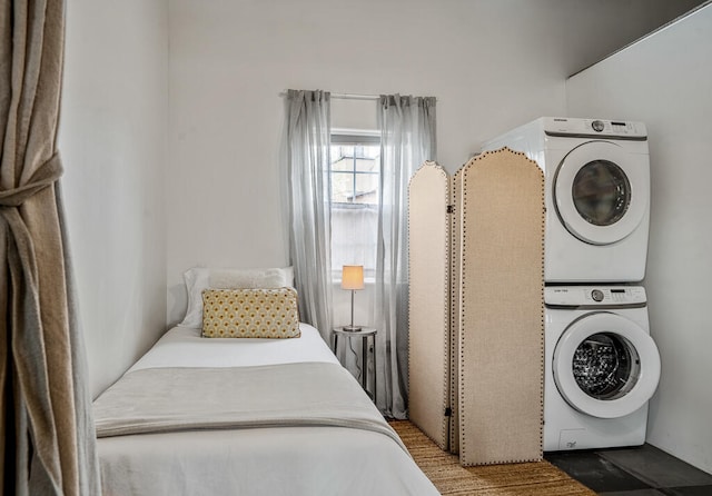 bedroom with stacked washer / dryer and light hardwood / wood-style flooring