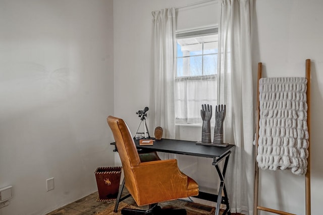 home office with wood-type flooring and a healthy amount of sunlight