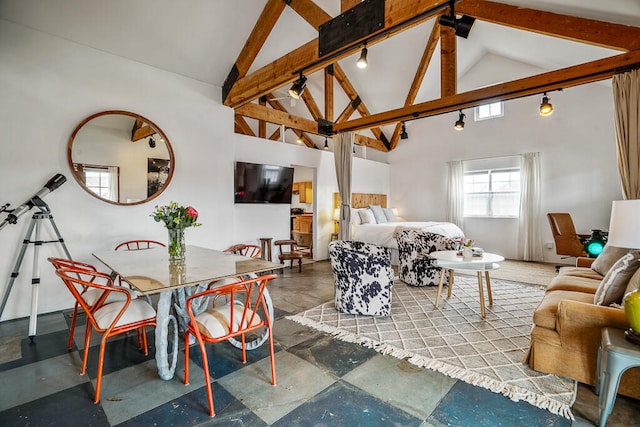 living room with beamed ceiling and high vaulted ceiling