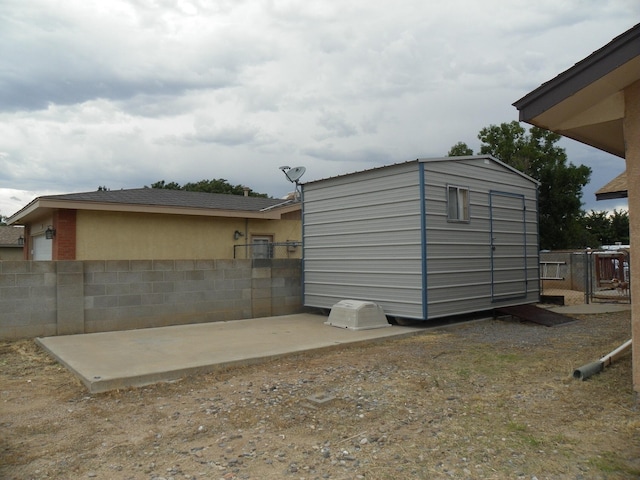 view of shed featuring fence