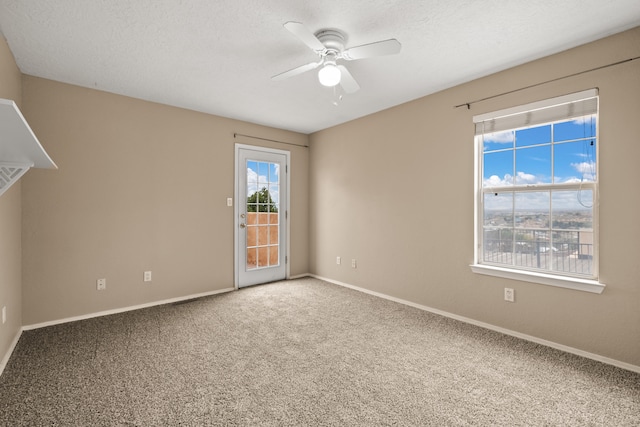 empty room with carpet flooring, a textured ceiling, and ceiling fan