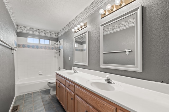 full bathroom featuring tile patterned floors, vanity, a textured ceiling, toilet, and tiled shower / bath