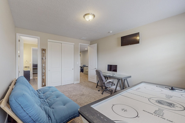 home office with carpet, baseboards, and a textured ceiling