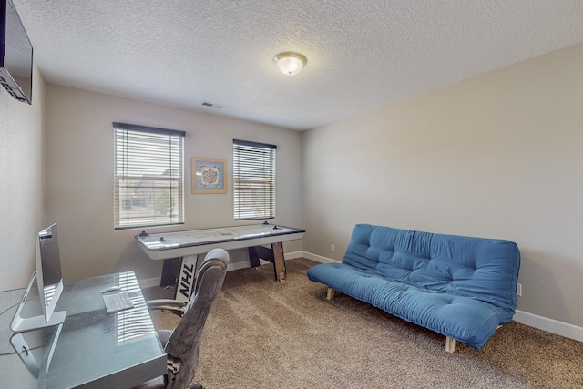 office space featuring baseboards, a textured ceiling, visible vents, and carpet flooring