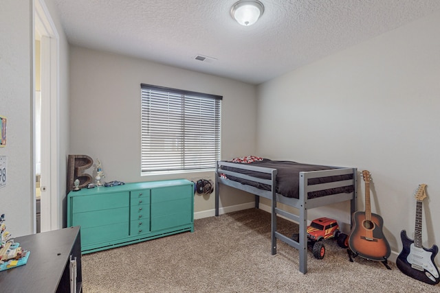 carpeted bedroom with a textured ceiling, visible vents, and baseboards