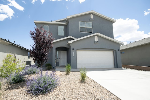 view of front of property with central AC unit and a garage