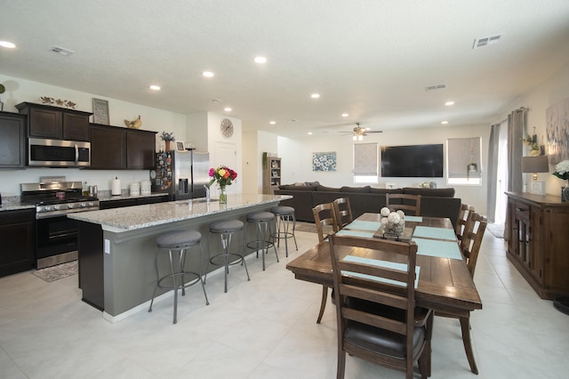 dining space with ceiling fan, plenty of natural light, and sink