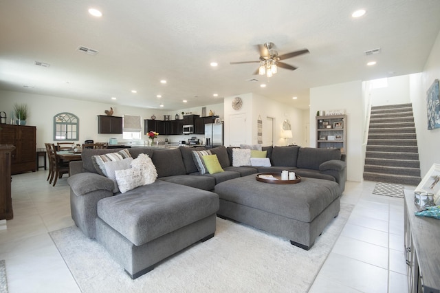 living room with ceiling fan and light tile patterned flooring