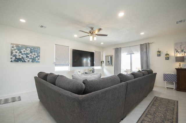 living room with light tile patterned floors and ceiling fan