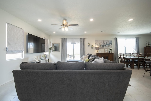 living room featuring light tile patterned flooring and ceiling fan