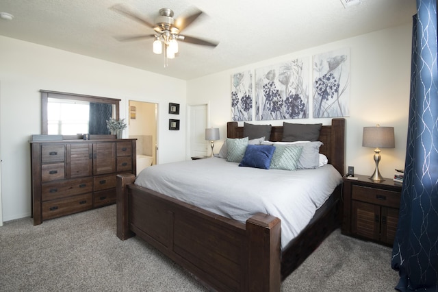 carpeted bedroom with ceiling fan and ensuite bathroom