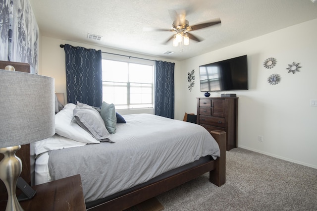 bedroom featuring carpet, a textured ceiling, and ceiling fan