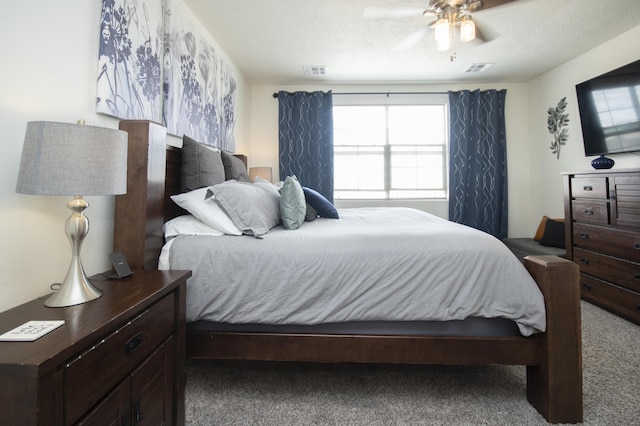 bedroom featuring carpet floors, a textured ceiling, and ceiling fan