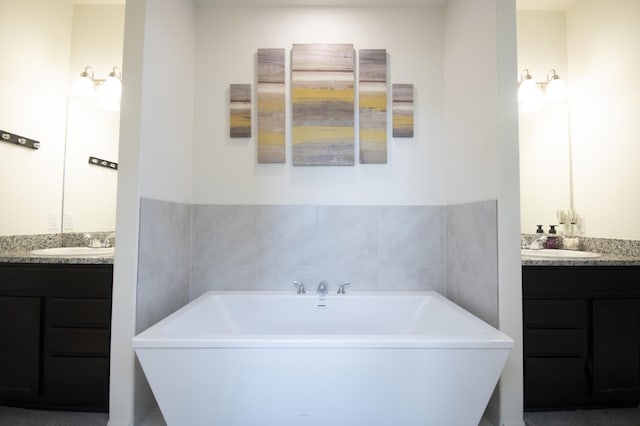 bathroom featuring vanity and a tub