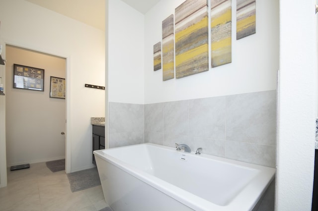 bathroom with vanity, tile patterned flooring, and a washtub