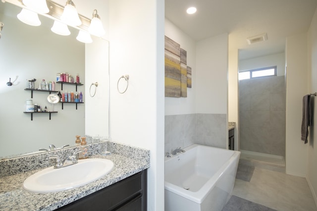 bathroom with vanity and independent shower and bath