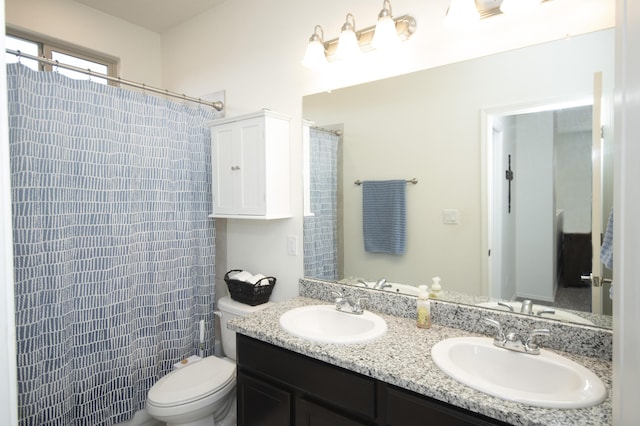 bathroom featuring vanity, toilet, and walk in shower