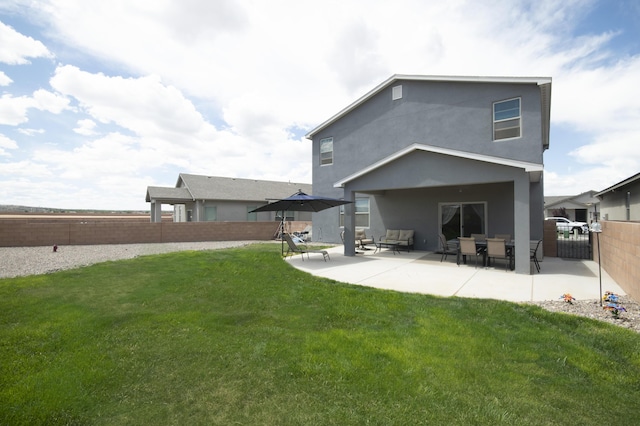 back of house with a yard and a patio area