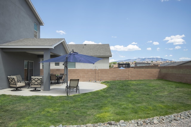 view of yard with a mountain view and a patio area