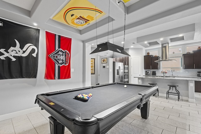 recreation room with light tile patterned floors, a tray ceiling, and billiards