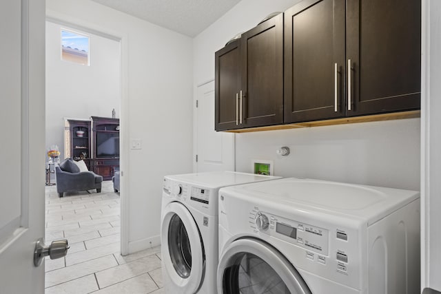 clothes washing area with cabinets, independent washer and dryer, a textured ceiling, and light tile patterned flooring