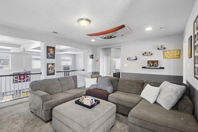 living room with a textured ceiling and carpet floors