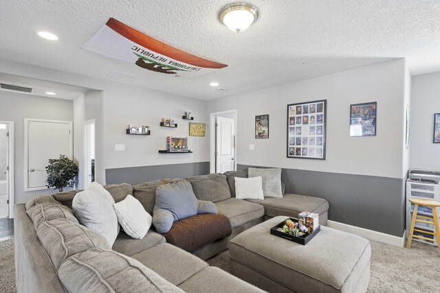 living room with carpet and a textured ceiling