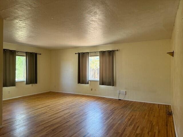 unfurnished room featuring hardwood / wood-style floors