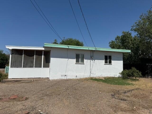 rear view of house featuring crawl space and a sunroom