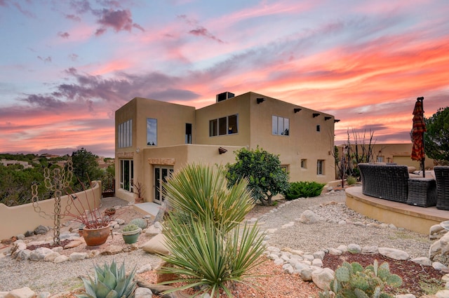 rear view of house featuring central AC and a patio area