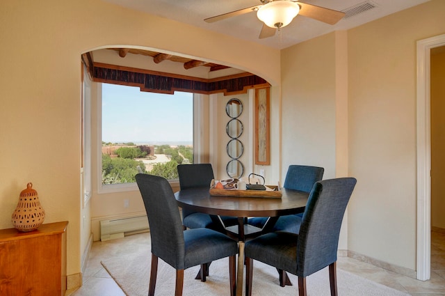 sitting room featuring light tile patterned floors, a textured ceiling, a mountain view, beam ceiling, and a baseboard radiator