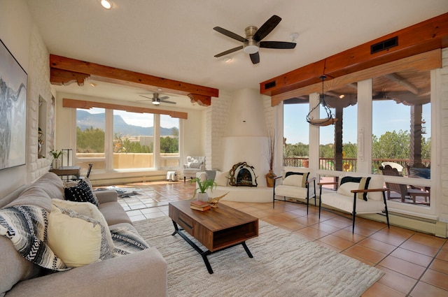 dining area with a baseboard radiator, light tile patterned floors, and ceiling fan