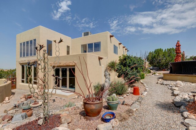 rear view of property with a lawn, a patio area, and an outdoor living space